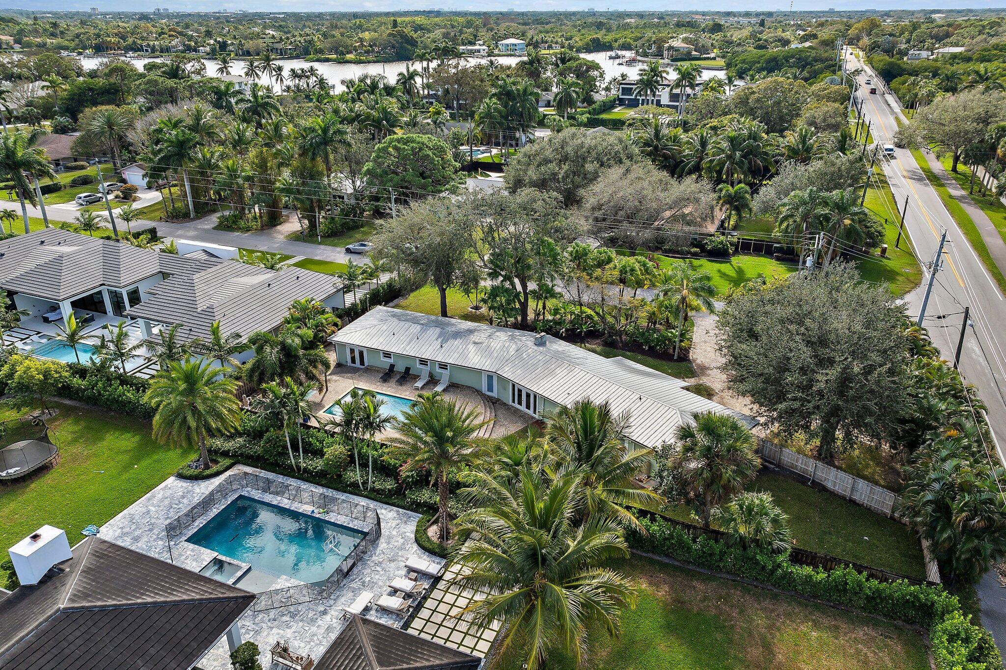 5692 Pennock Point Road Jupiter, FL 33458 - Photo 50 of 51 an aerial view of a house with a garden and lake view