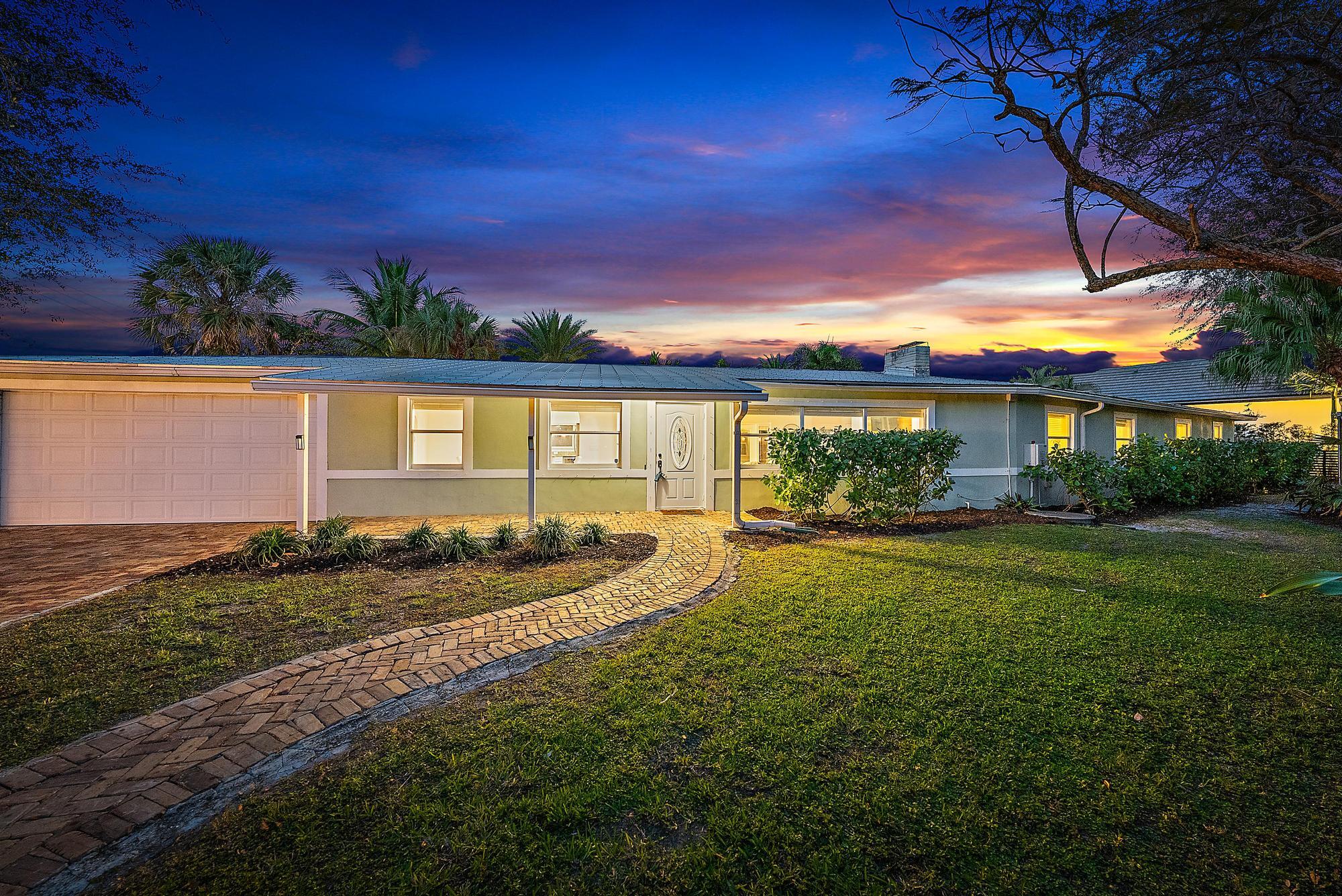5692 Pennock Point Road Jupiter, FL 33458 - Photo 7 of 51 a view of a house with garden and patio