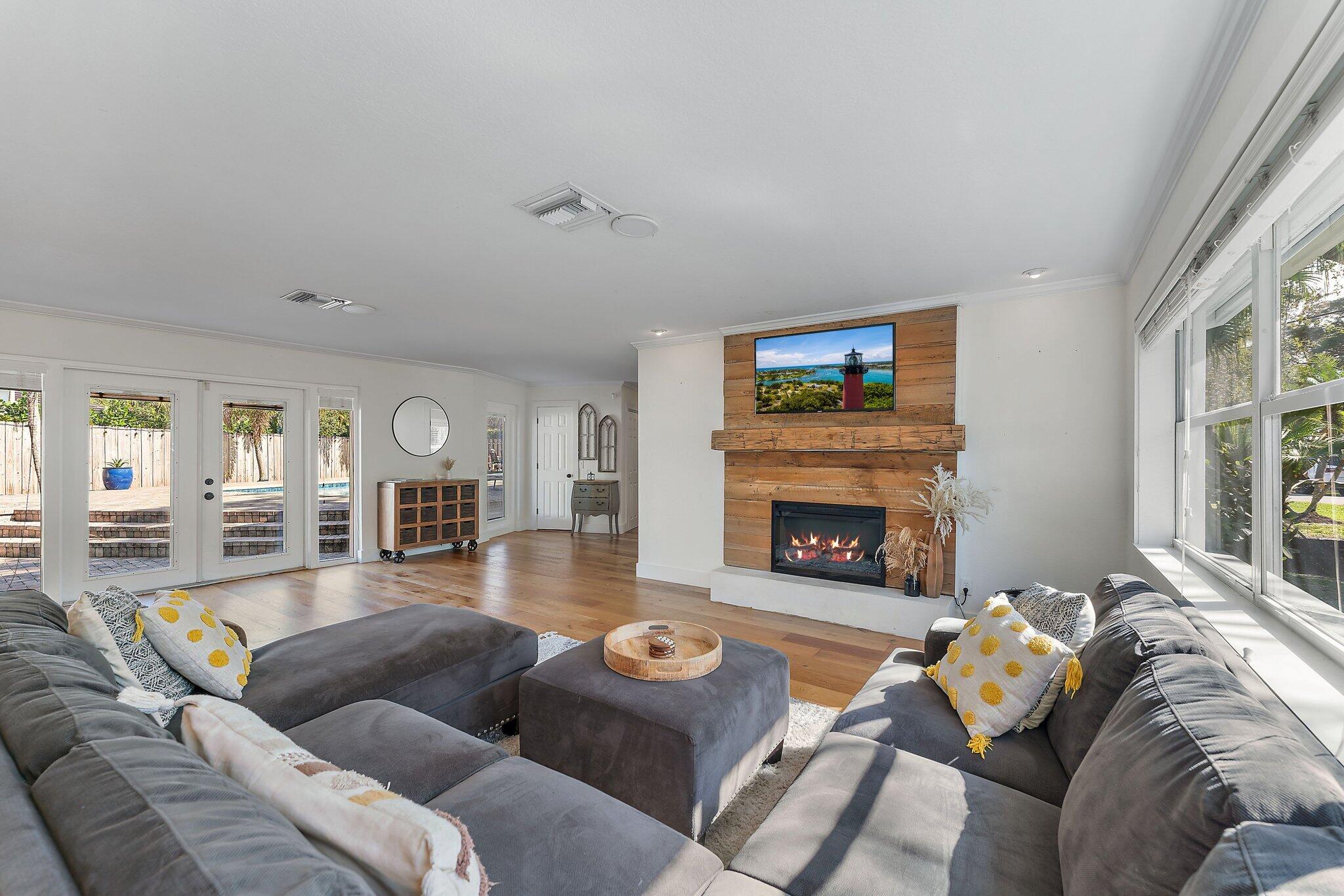 5692 Pennock Point Road Jupiter, FL 33458 - Photo 8 of 51 a living room with furniture and a fireplace