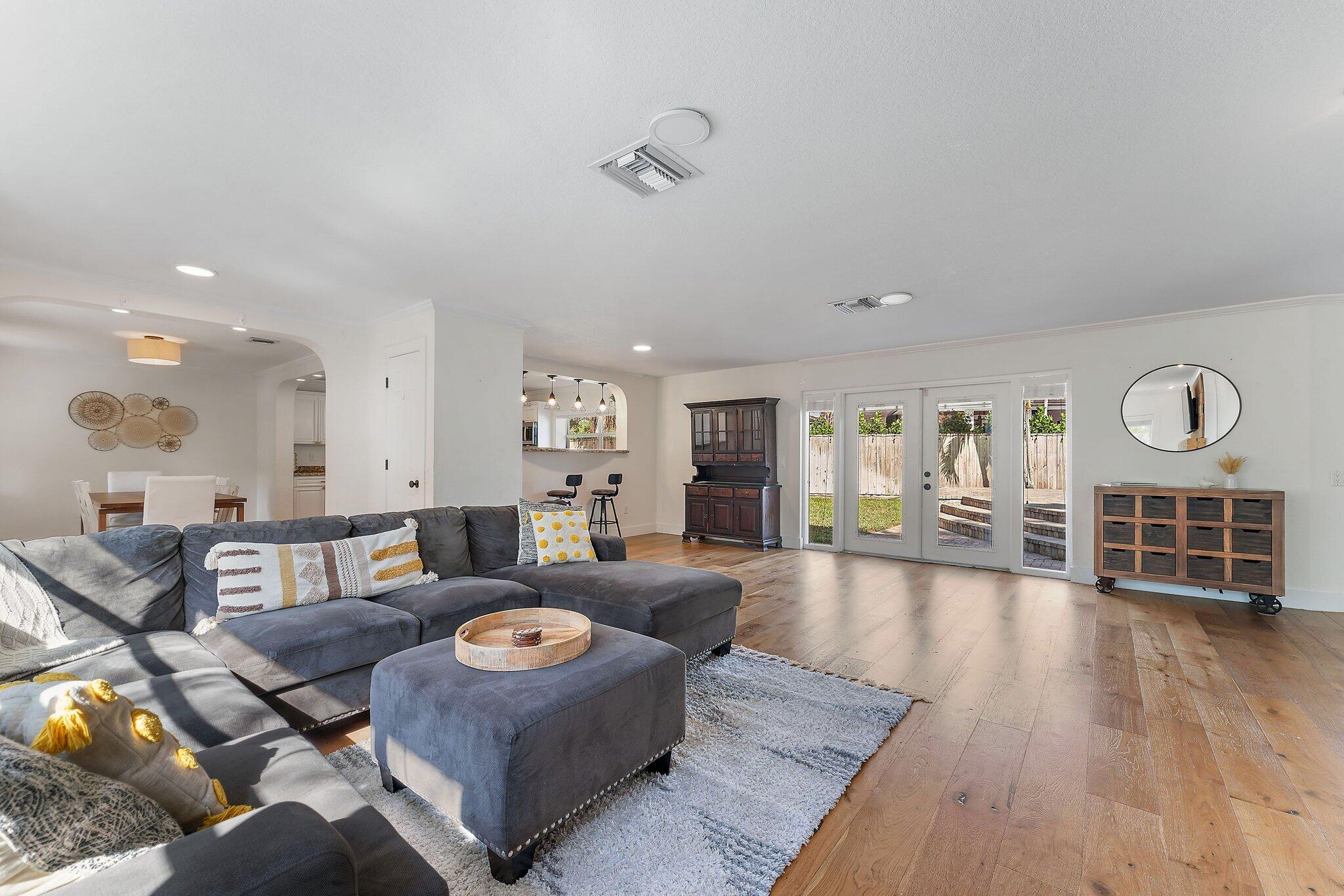 5692 Pennock Point Road Jupiter, FL 33458 - Photo 9 of 51 a living room with furniture and a wooden floor