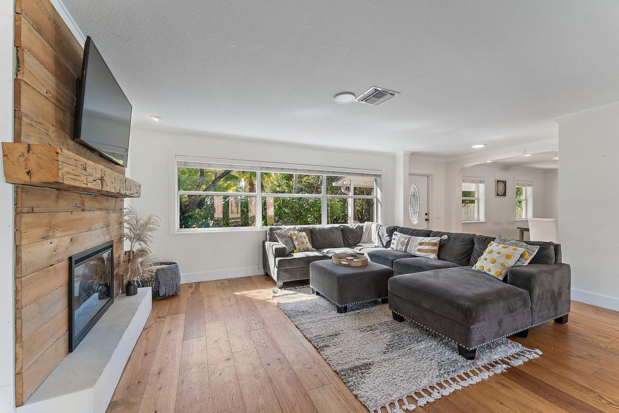 5692 Pennock Point Road Jupiter, FL 33458 - Photo 10 of 51 a living room with furniture fireplace and flat screen tv