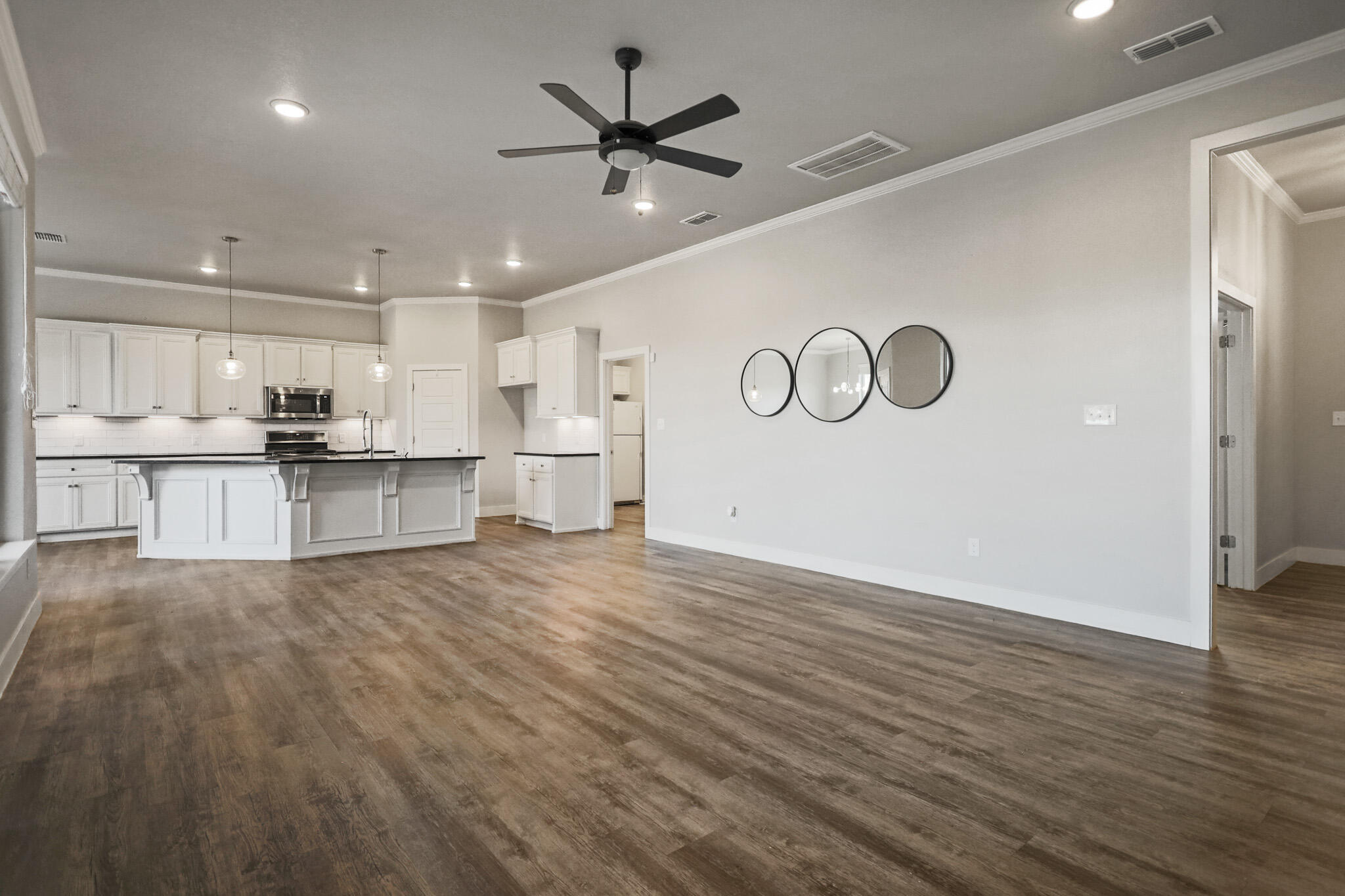 7808 58th Street Lubbock, TX 79407 - Photo 17 of 50 a view of kitchen with wooden floor and window