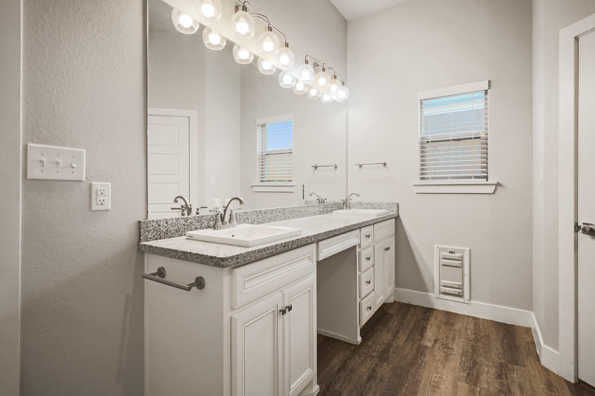 7808 58th Street Lubbock, TX 79407 - Photo 28 of 50 a bathroom with a granite countertop sink a large mirror and a vanity