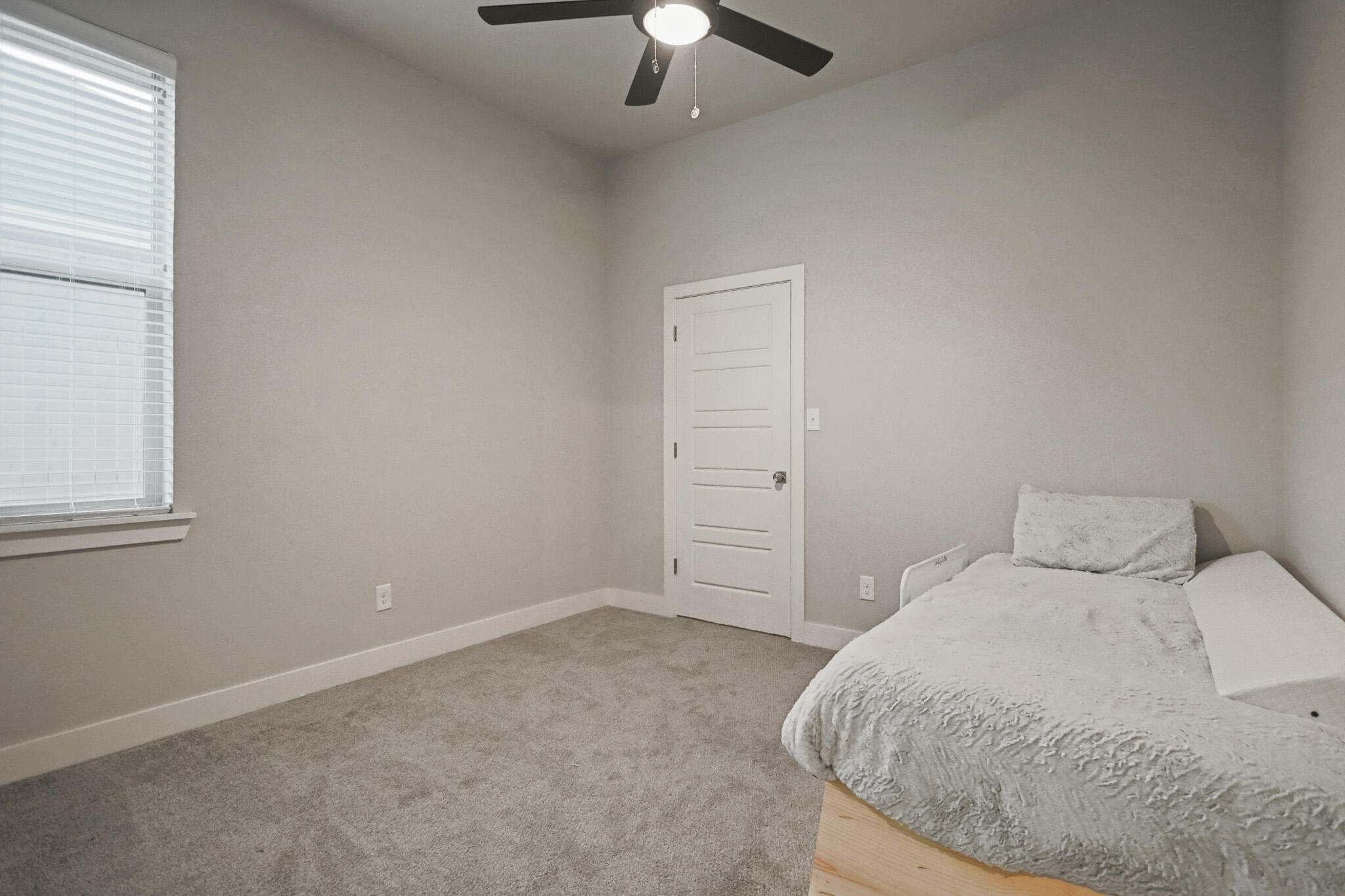 7808 58th Street Lubbock, TX 79407 - Photo 32 of 50 a bedroom with a bed and a chandelier fan