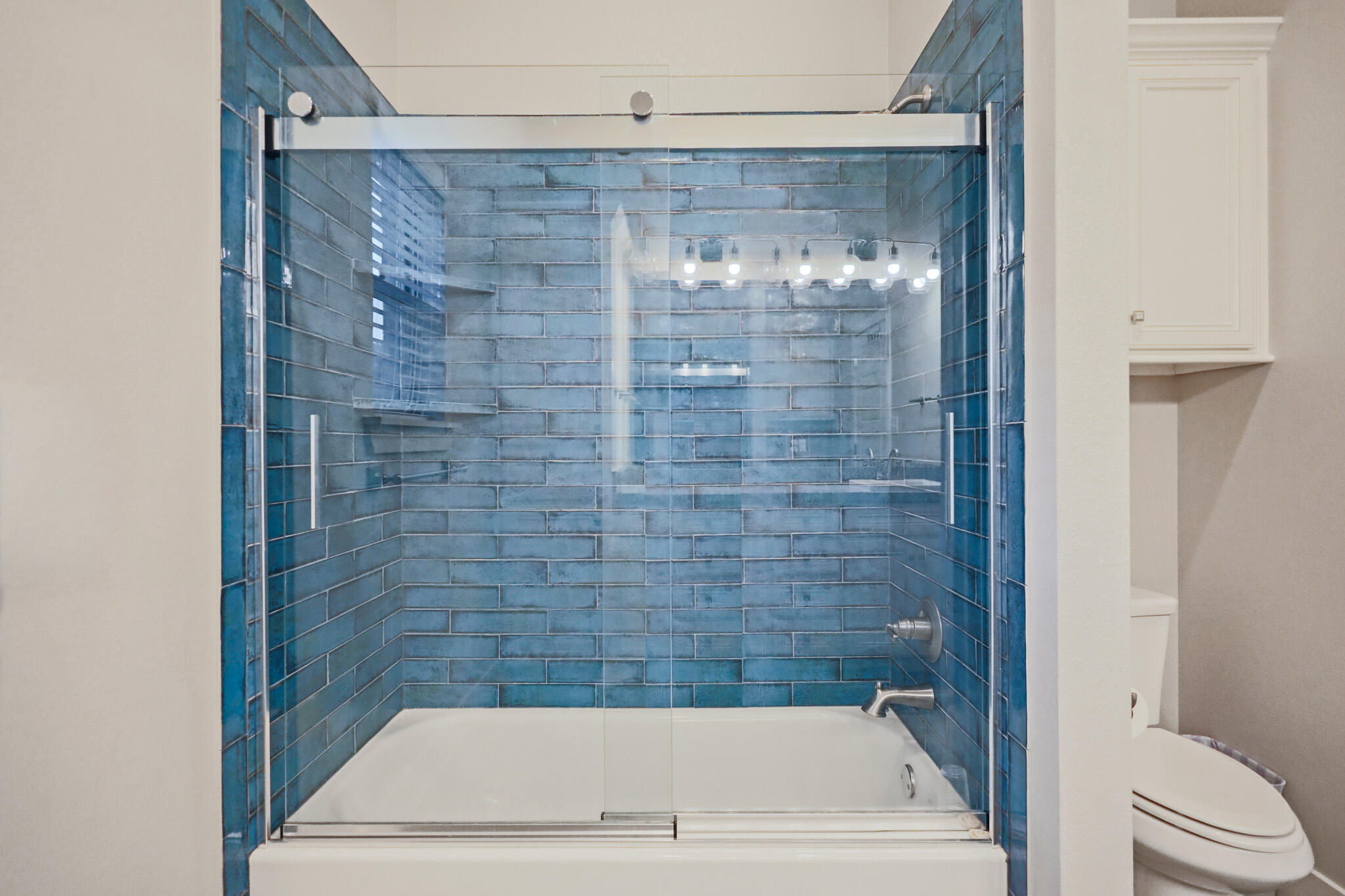 7808 58th Street Lubbock, TX 79407 - Photo 37 of 50 a bathroom with a bathtub and a shower