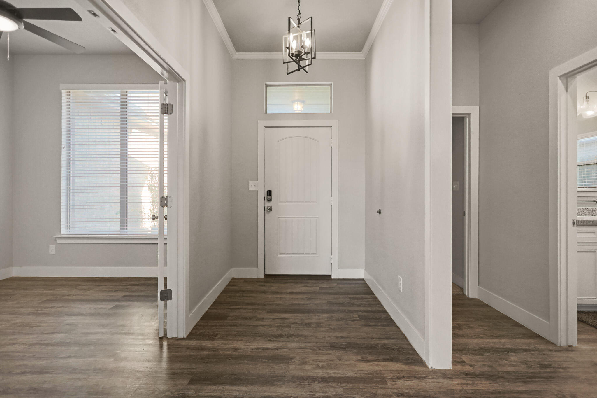 7808 58th Street Lubbock, TX 79407 - Photo 4 of 50 a view of a hallway with wooden floor and staircase