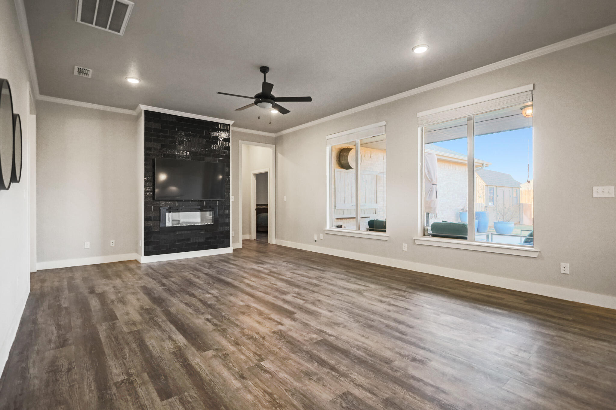 7808 58th Street Lubbock, TX 79407 - Photo 6 of 50 a view of empty room with wooden floor and fan