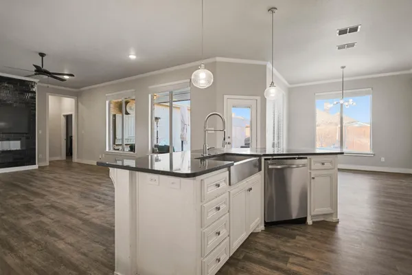 a bedroom with a bed and a chandelier fan