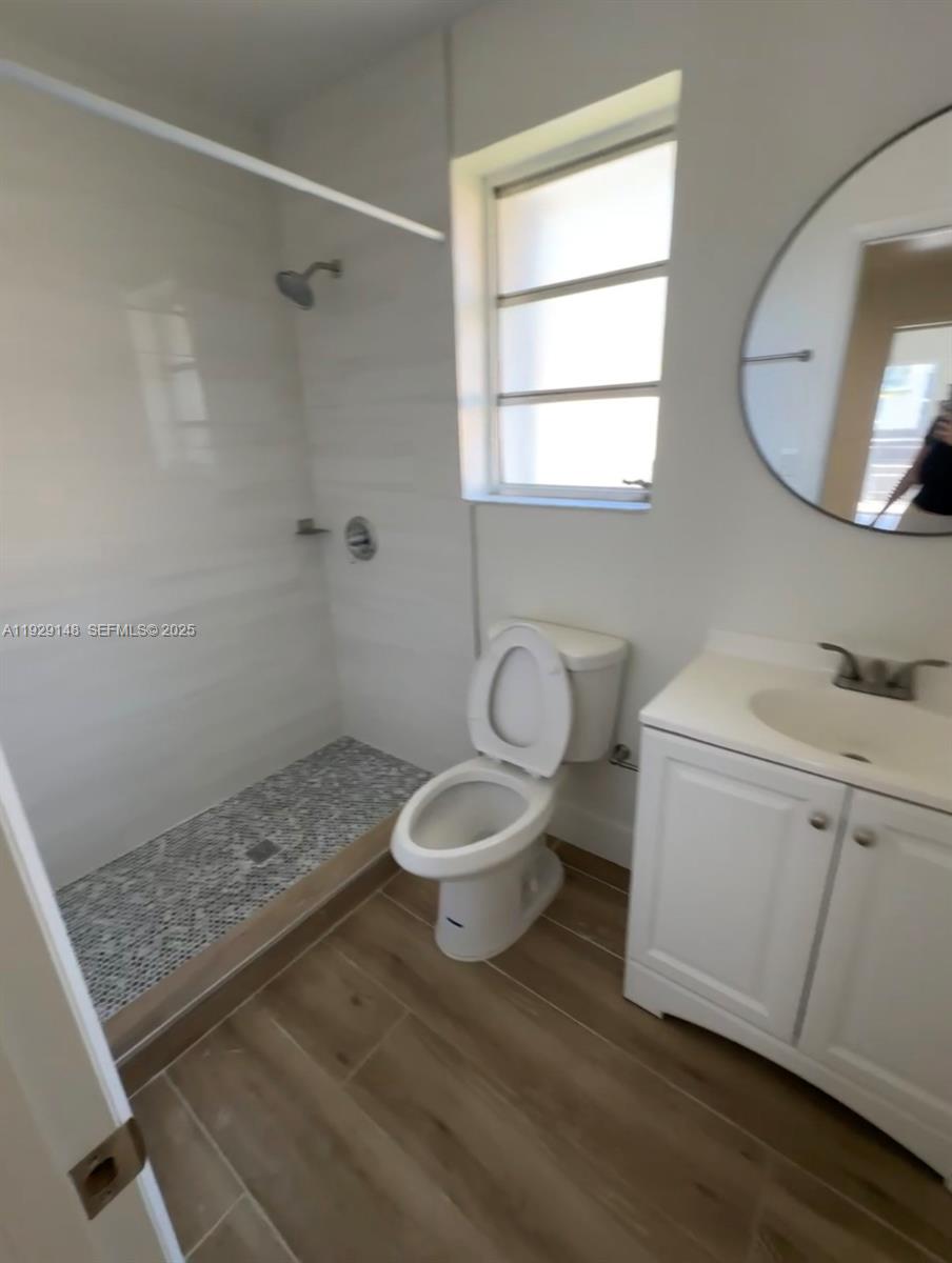 111 Southwest 31st Court, Unit 4 Miami, FL 33135 - Photo 6 of 6 a bathroom with a toilet a sink and mirror