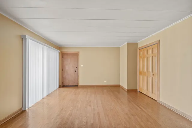a view of an empty room with wooden floor
