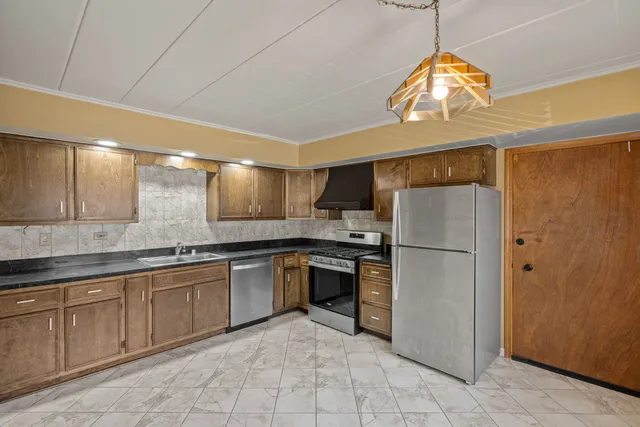 a kitchen with a refrigerator a sink and dishwasher
