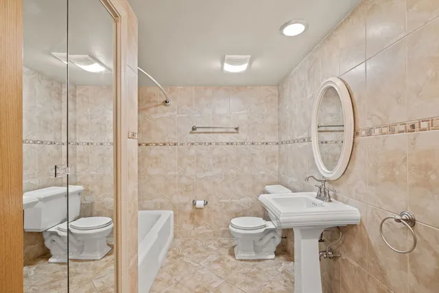 a bathroom with a sink toilet and a shower