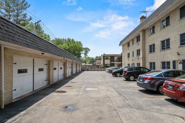 a view of a cars park in front of a building