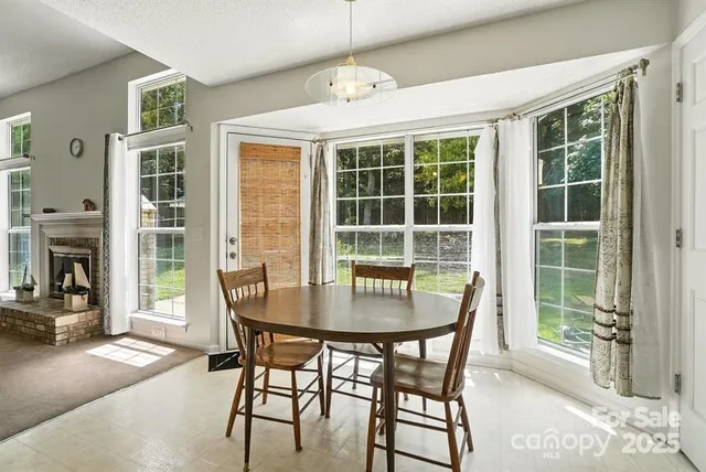 a dining room with furniture and a chandelier