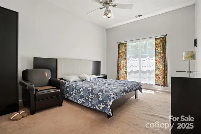 a bedroom with a bed and a couch