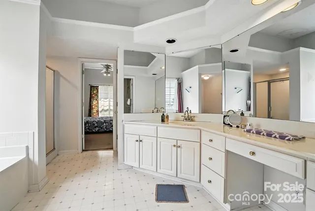 a spacious bathroom with a granite countertop sink mirror and shower