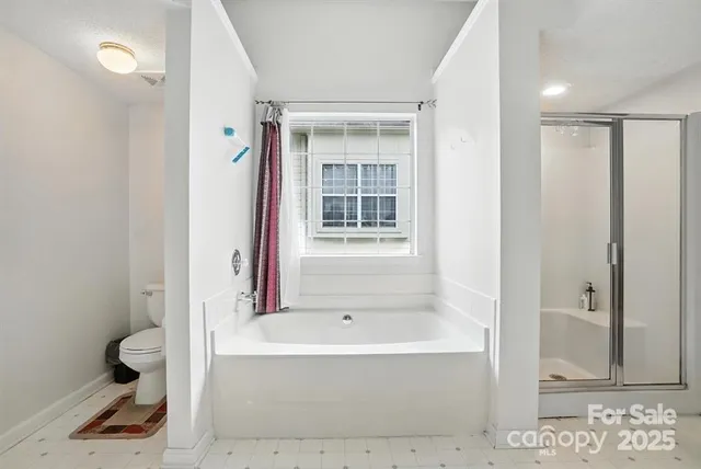 a bathroom with a bathtub and a shower