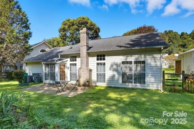 a view of a chair and table in the garden