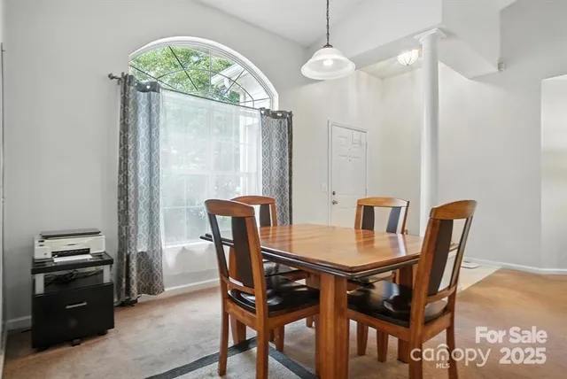 a view of a dining room with furniture and a chandelier