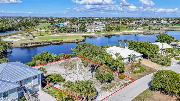 an aerial view of a house with a garden and lake view