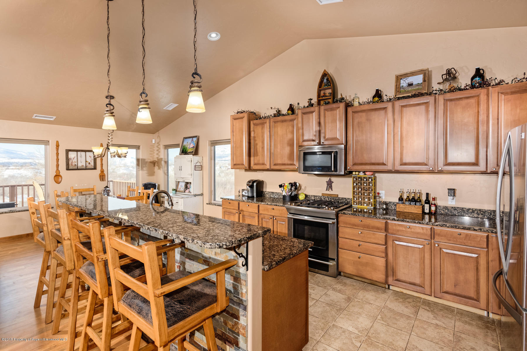 1327 Clover Court Rifle, CO 81650 - Photo 4 of 21 a kitchen with granite countertop a sink a stove and cabinets