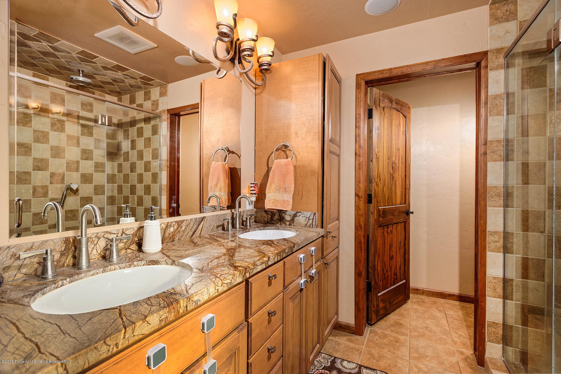 1327 Clover Court Rifle, CO 81650 - Photo 10 of 21 a bathroom with a granite countertop double vanity sink a mirror and a shower