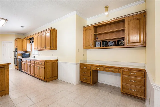 a kitchen with stainless steel appliances a stove and more cabinets