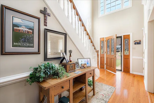 a view of an entryway with wooden floor and windows