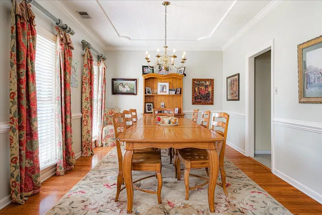 a view of a dining room with furniture window and wooden floor