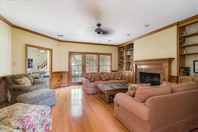a living room with furniture large window and a fireplace