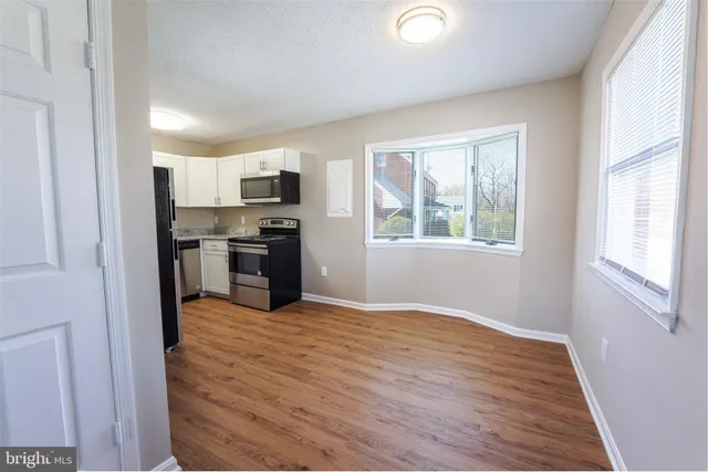 a view of a kitchen with microwave and stove top oven