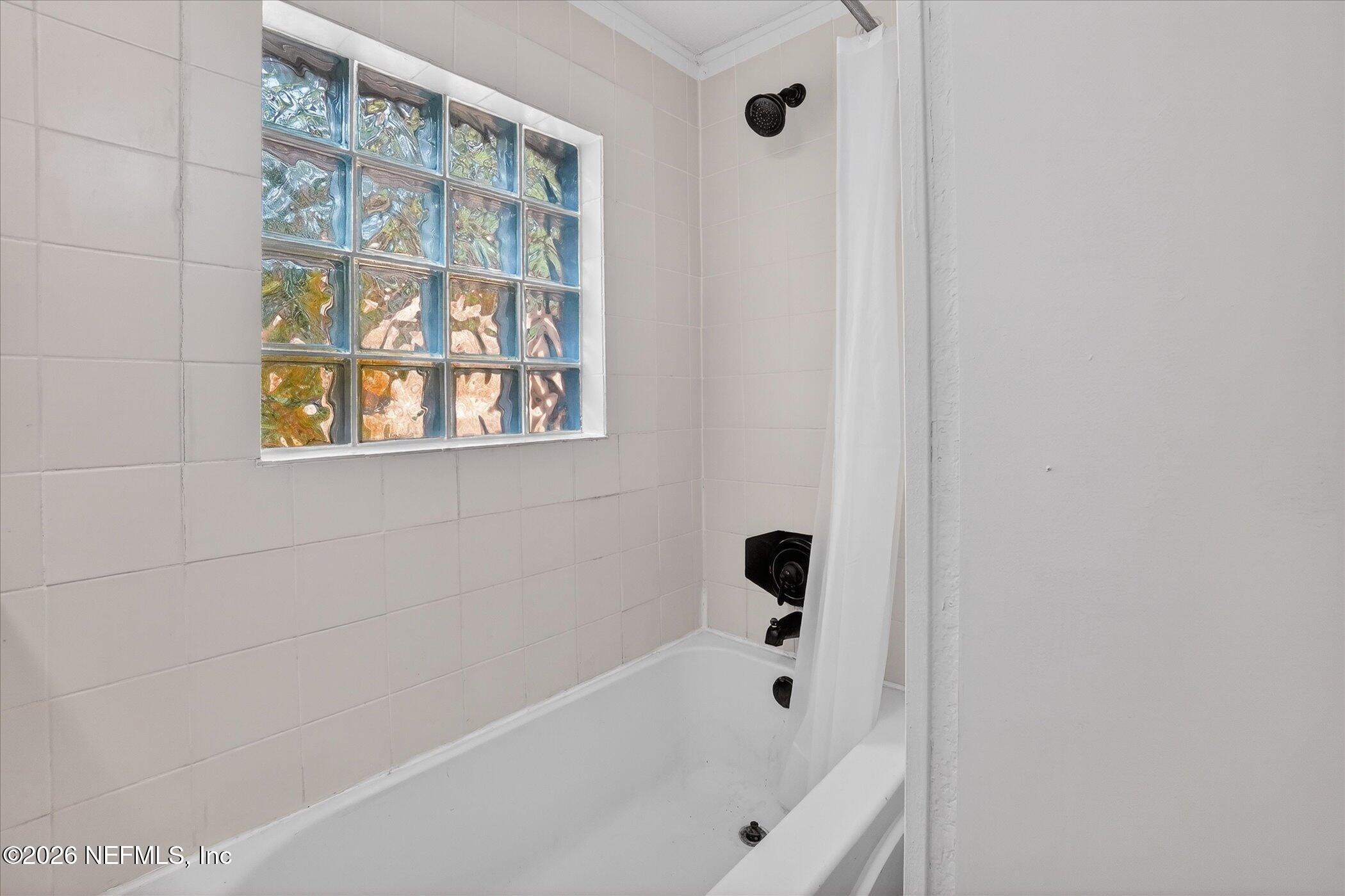 1217 Cook Street Jacksonville, FL 32205 - Photo 11 of 43 a bathroom with a bathtub and a shower