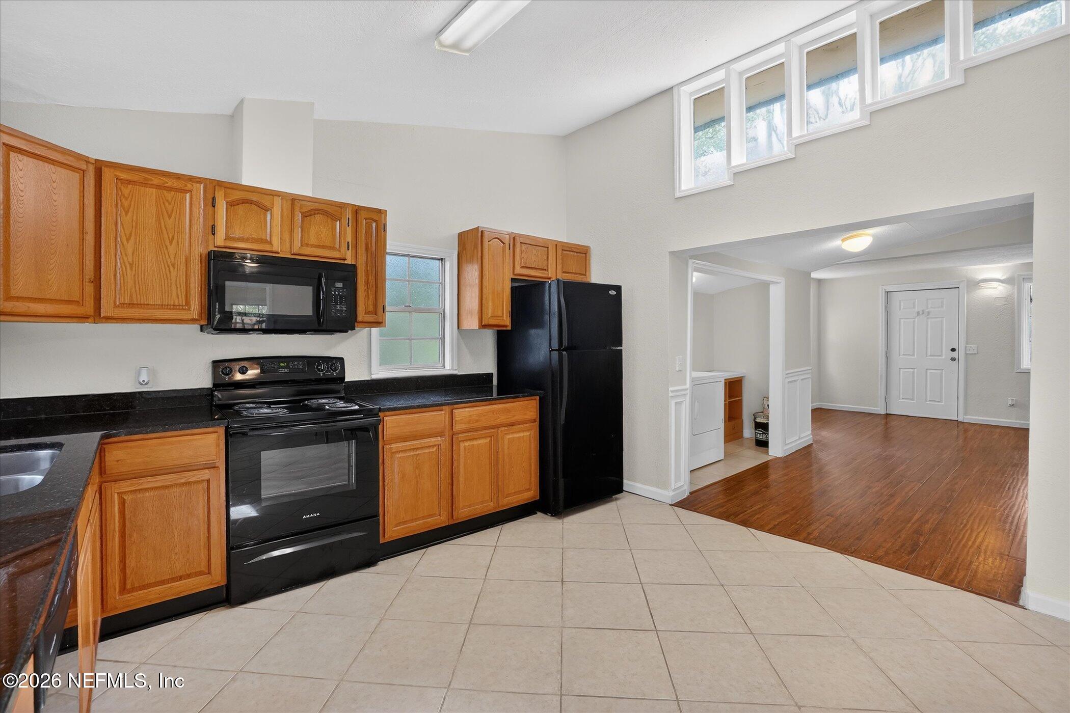 1217 Cook Street Jacksonville, FL 32205 - Photo 26 of 43 a kitchen with stainless steel appliances granite countertop a refrigerator and a stove top oven