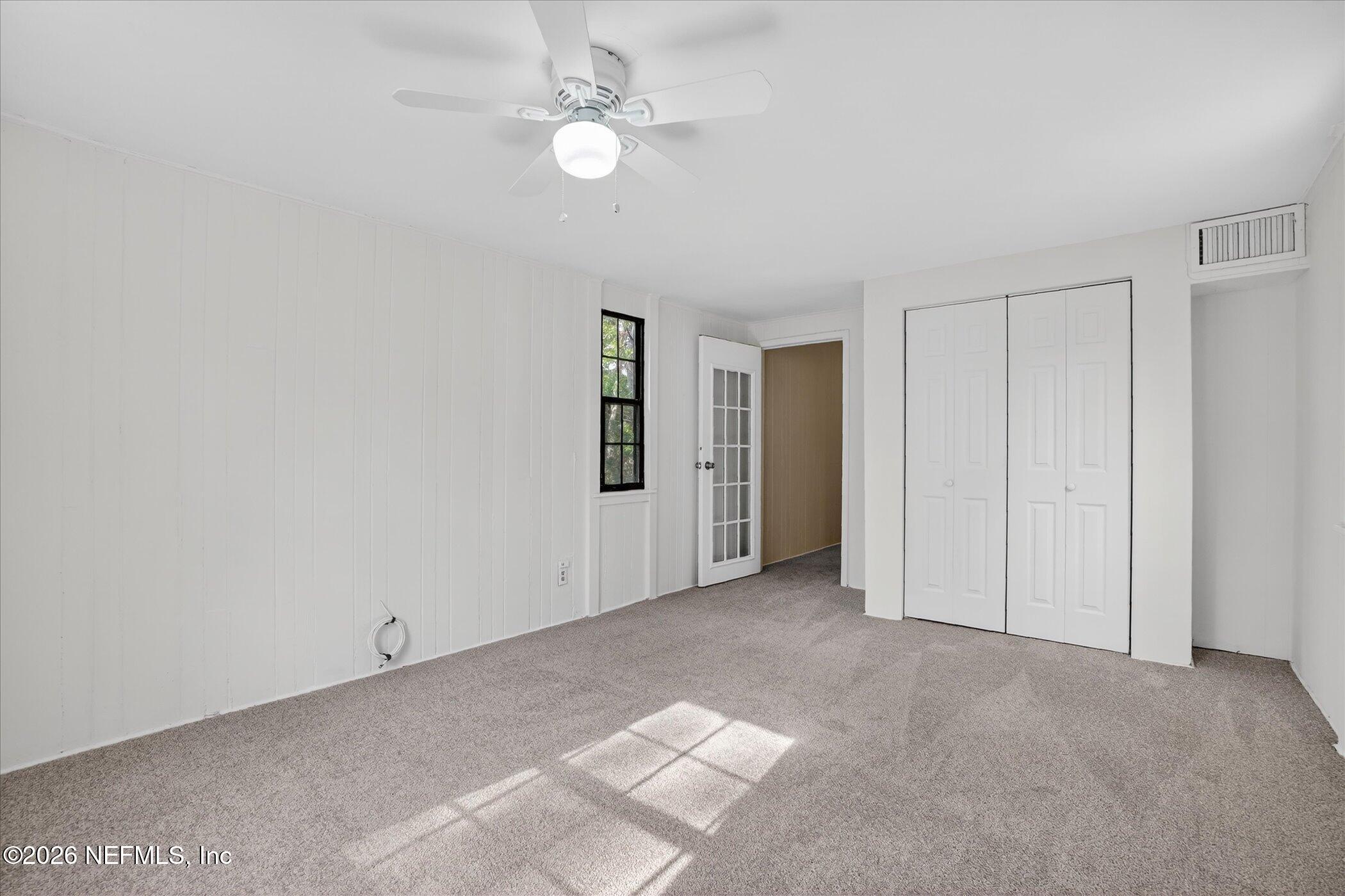 1217 Cook Street Jacksonville, FL 32205 - Photo 34 of 43 an empty room with a ceiling fan and a window