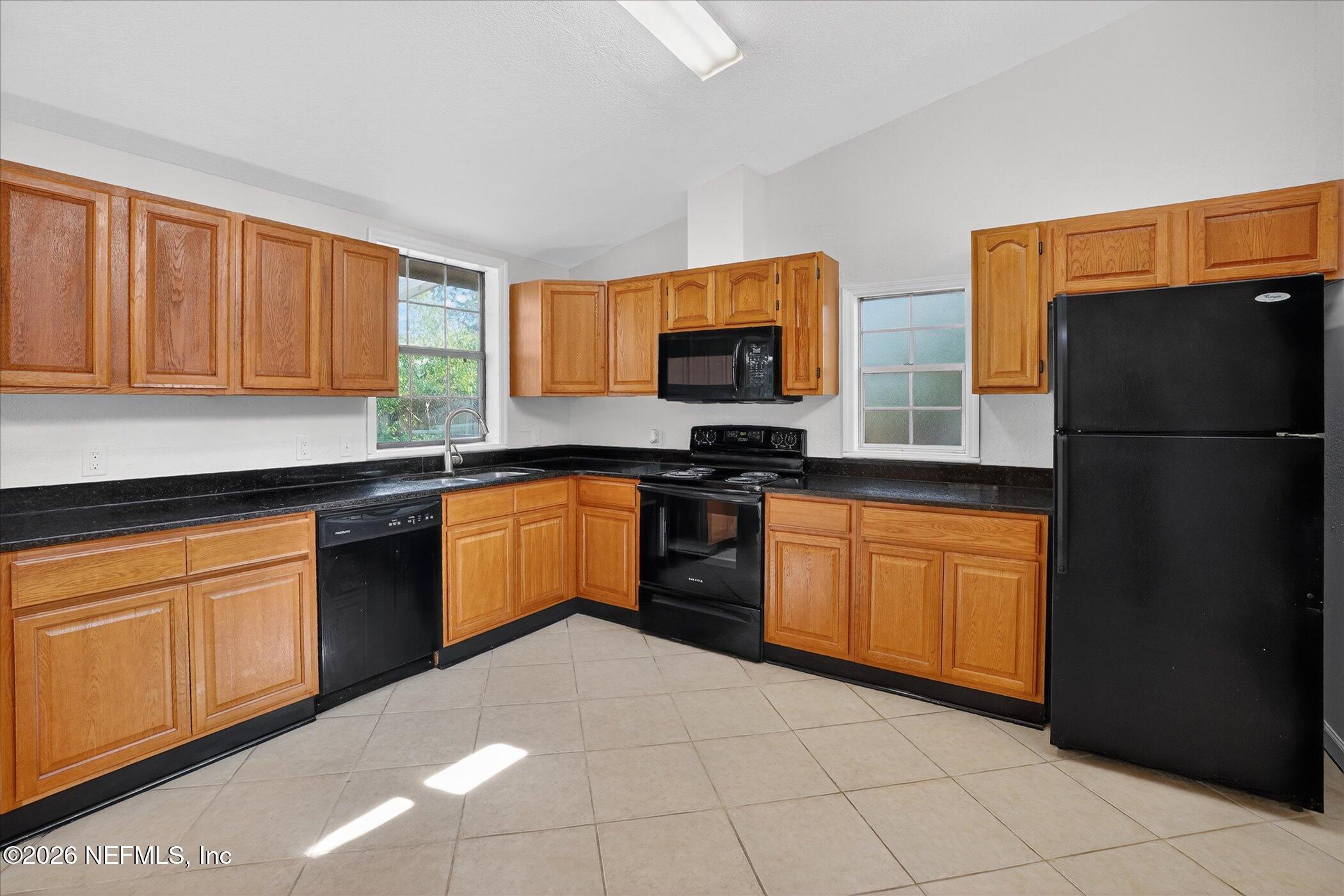 1217 Cook Street Jacksonville, FL 32205 - Photo 5 of 43 a kitchen with stainless steel appliances granite countertop a refrigerator sink and cabinets