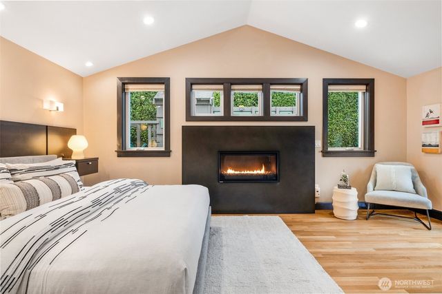 a bedroom with a large bed and a fireplace