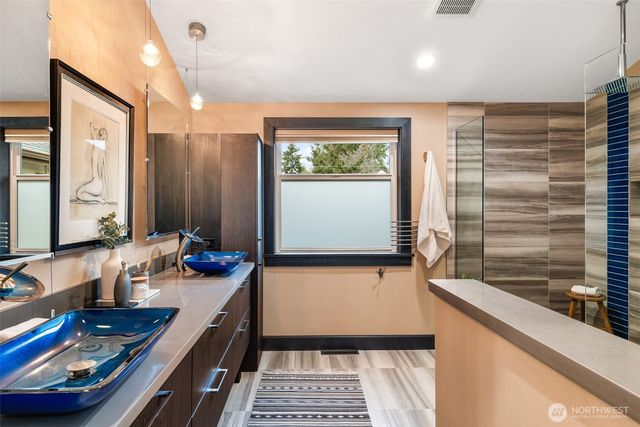 a view of walk in closet with clothes
