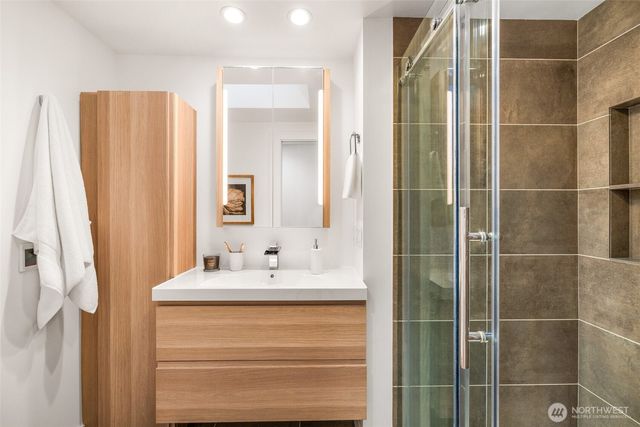 a bathroom with a shower and a mirror