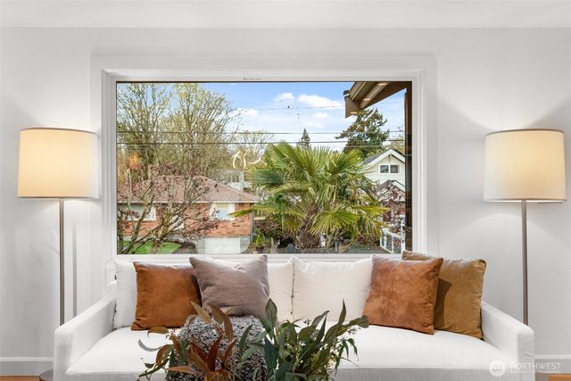 a living room with a large window and a table