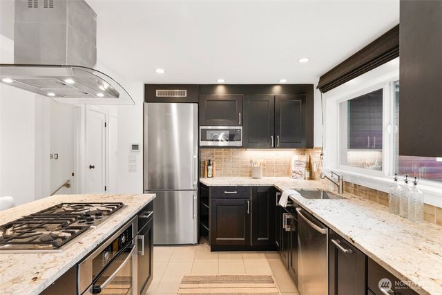 a kitchen with a sink and stainless steel appliances