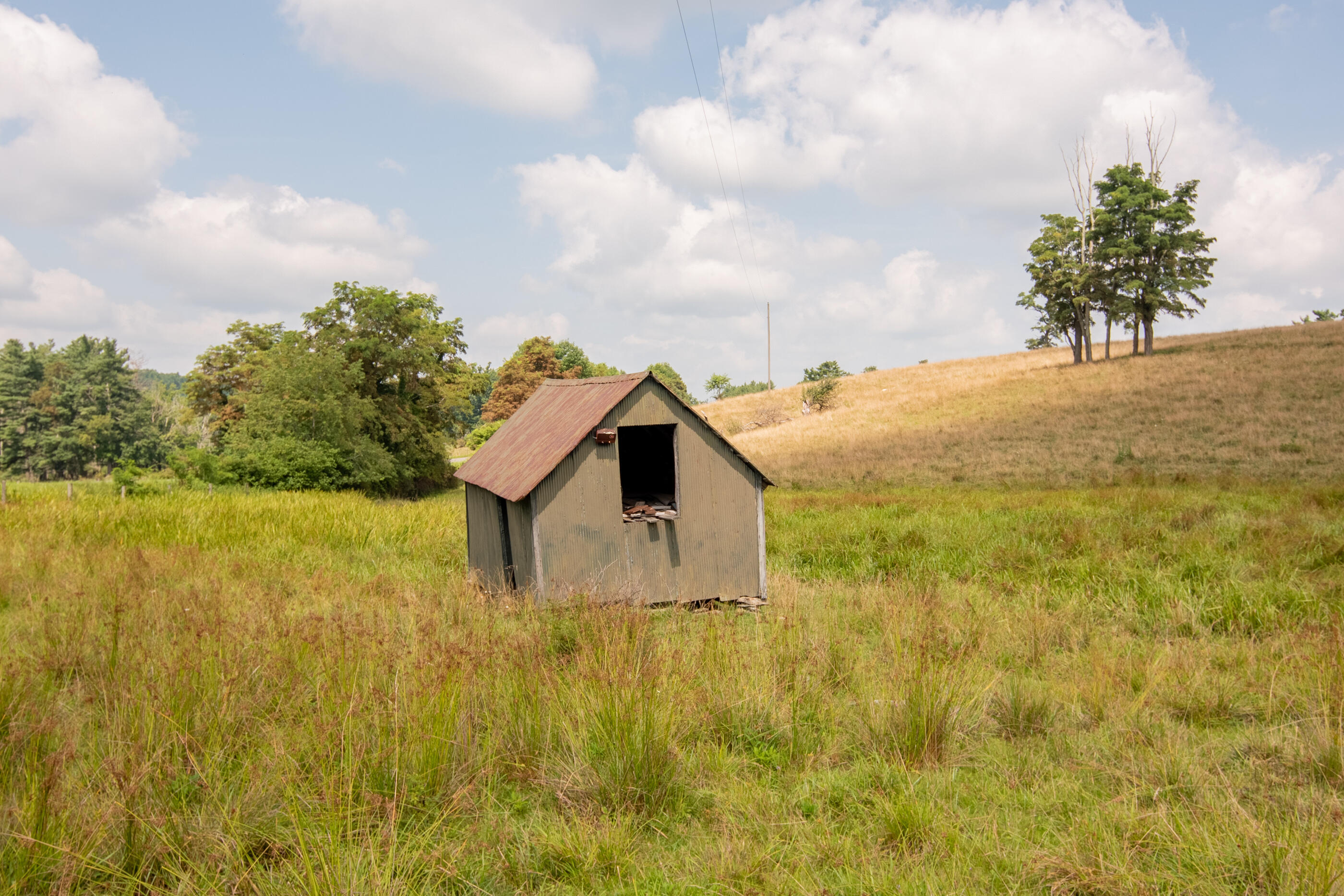 767 Kyle Weeks Road Southwest Willis, VA 24380 - Photo 15 of 86 a yellow house with swimming pool in front of it