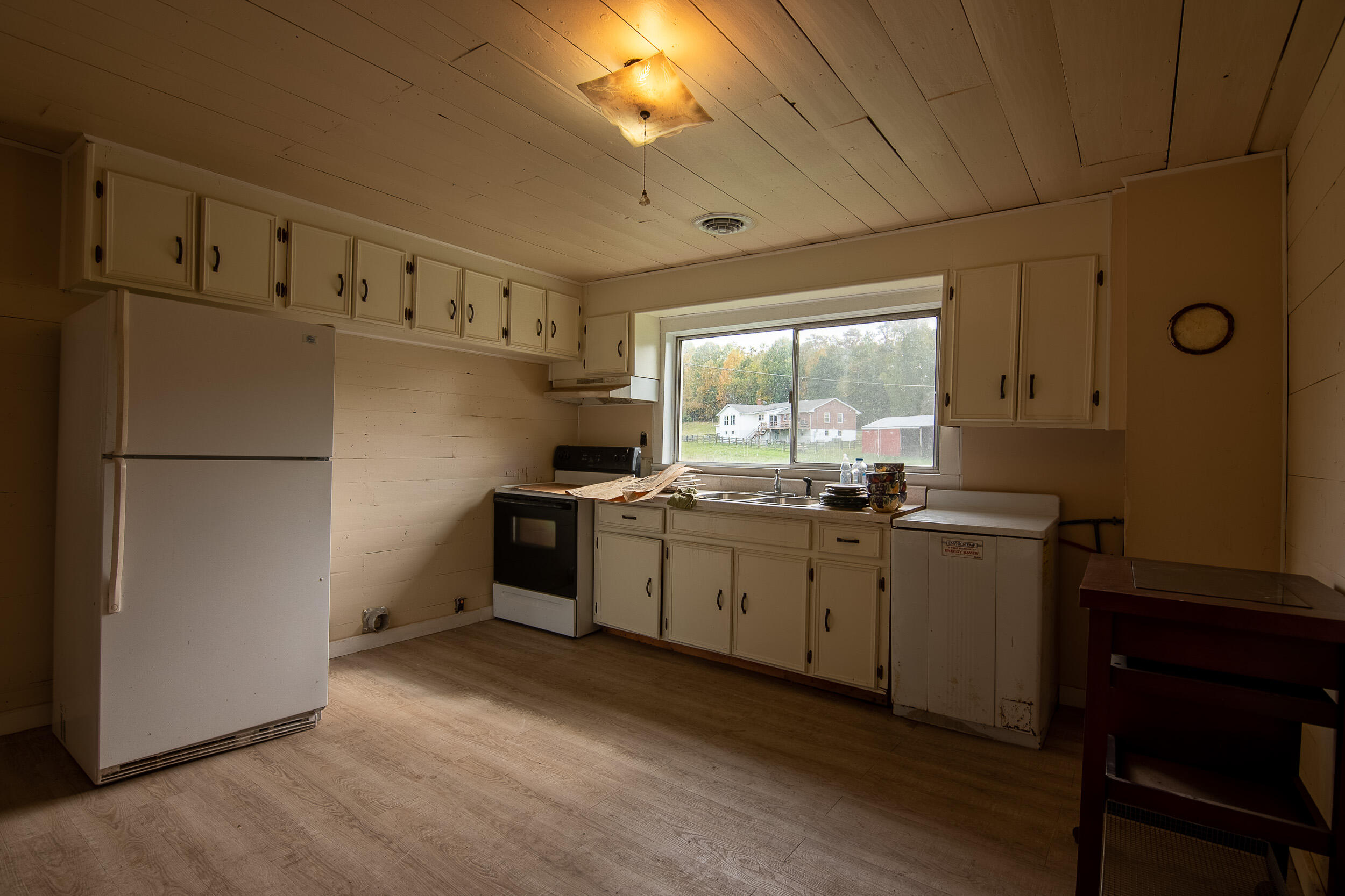 767 Kyle Weeks Road Southwest Willis, VA 24380 - Photo 39 of 86 a kitchen with cabinets a refrigerator and a sink