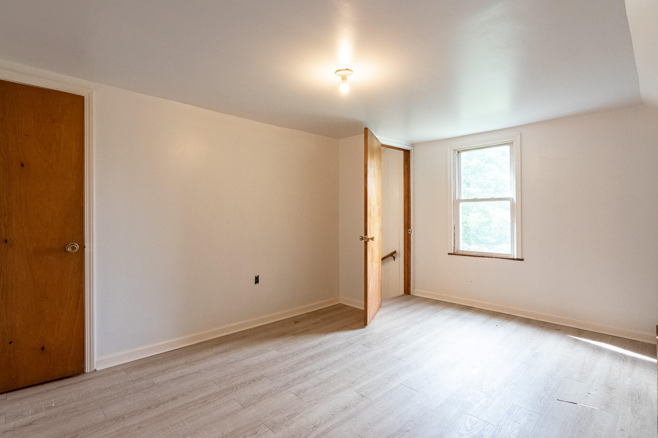 767 Kyle Weeks Road Southwest Willis, VA 24380 - Photo 48 of 86 an empty room with wooden floor and windows
