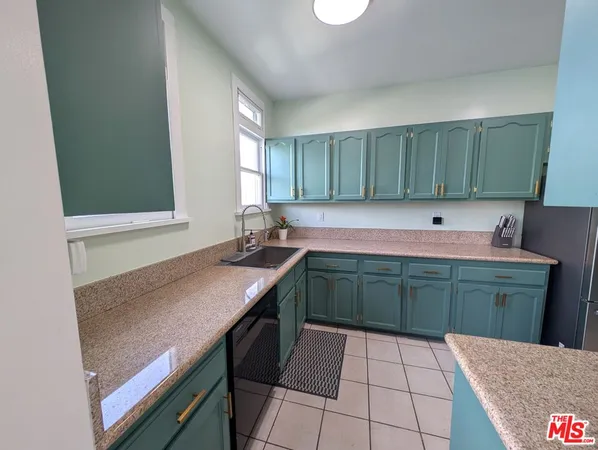 a kitchen with a sink cabinets and window