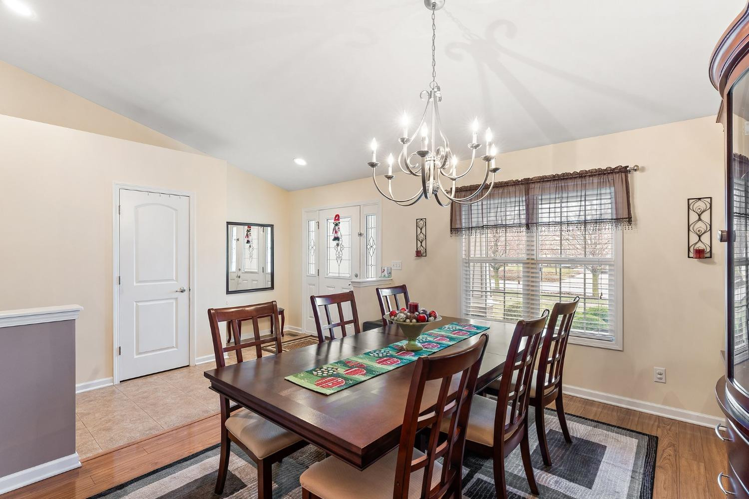 10331 Nelson Street Crown Point, IN 46307 - Photo 13 of 47 a view of a dining room with furniture a chandelier and wooden floor