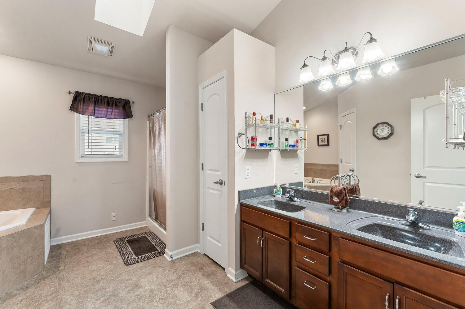 10331 Nelson Street Crown Point, IN 46307 - Photo 32 of 47 a spacious bathroom with a double vanity sink and a mirror