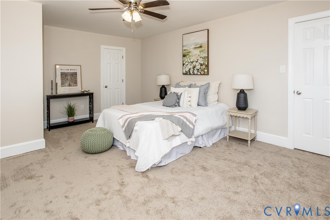 13110 Hensley Road Midlothian, VA 23112 - Photo 16 of 24 a bedroom with a bed and a chandelier