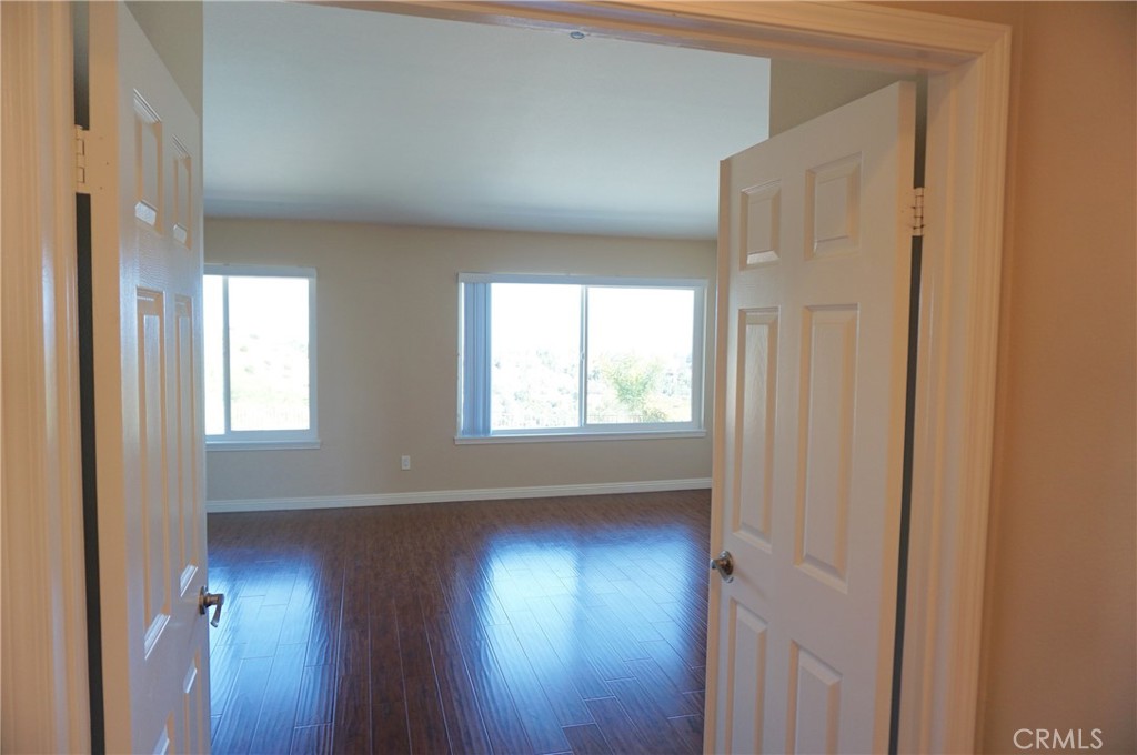 19584 Shadow Glen Circle Porter Ranch, CA 91326 - Photo 21 of 72 a view of empty room with wooden floor and fan