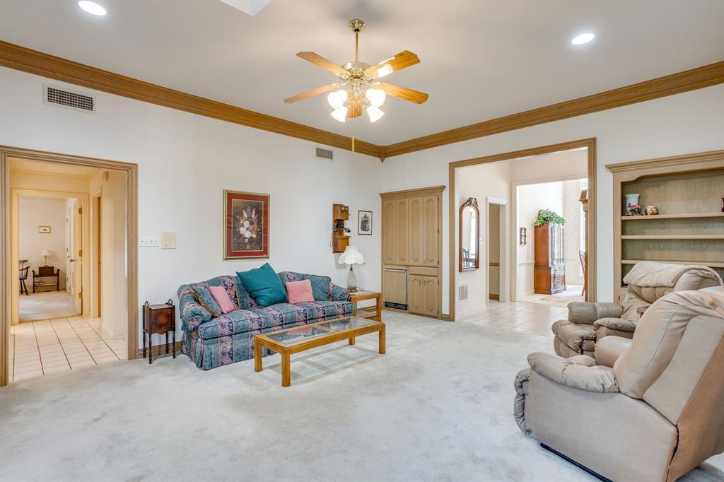 3068 High Ridge Drive Grapevine, TX 76051 - Photo 10 of 40 Spacious living area featuring a ceiling fan, recessed lighting, built-in cabinetry, wood-finish trim, and built-in shelving