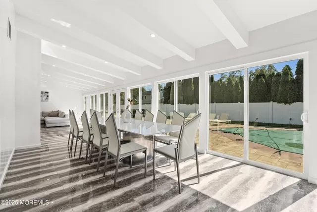 a view of a dining room with furniture wooden floor and garden view